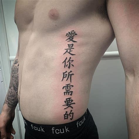 back and rib tattoos|rib tatoo men.